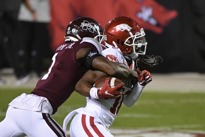 Mississippi State cornerback Martin Emerson (1) tackles Arkansas wide receiver De'Vion Warren (10) after a catch during the first half of an NCAA college football game in Starkville, Miss., Saturday, Oct. 3, 2020.