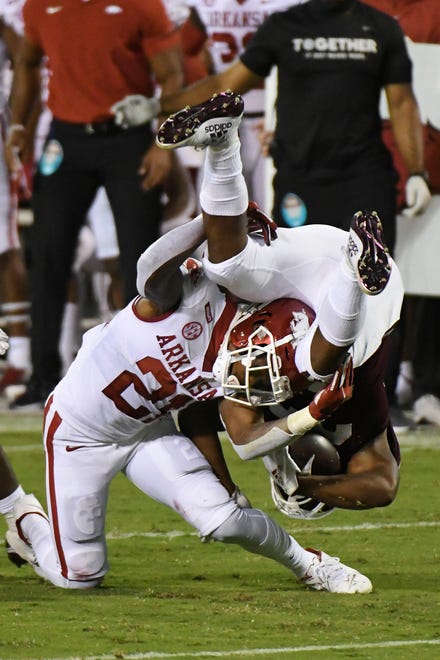 Arkansas defensive back Montaric Brown (21) tackles Mississippi State running back Dillon Johnson during the first half of an NCAA college football game in Starkville, Miss., Saturday, Oct. 3, 2020.