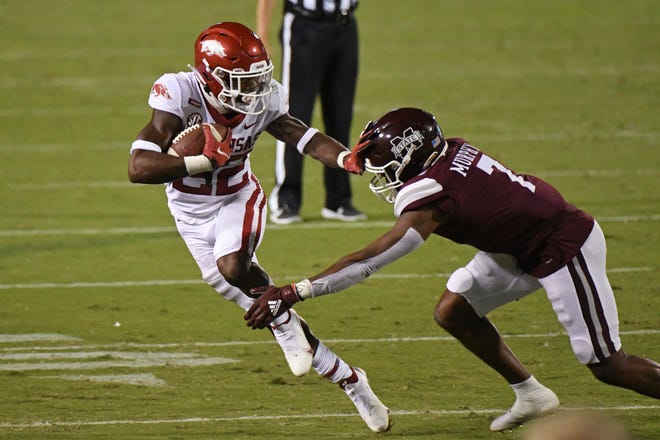 Arkansas running back Trelon Smith (22) looks for room past Mississippi State safety Marcus Murphy (7) during the first half of an NCAA college football game in Starkville, Miss., Saturday, Oct. 3, 2020.