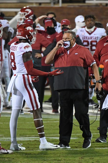 Arkansas coach Sam Pittman talks to wide receiver Mike Woods (8) during the second half of the team's NCAA college football game against Mississippi State in Starkville, Miss., Saturday, Oct. 3, 2020. Arkansas won 21-14.