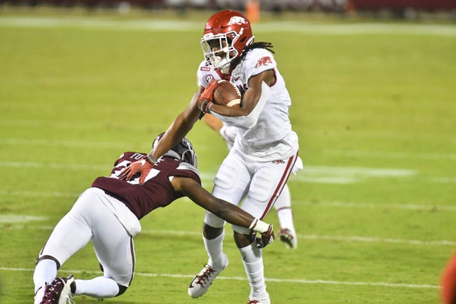 Oct 3, 2020; Starkville, Mississippi, USA;  Arkansas Razorbacks wide receiver Trey Knox (7) carries the ball while defended by Mississippi State Bulldogs cornerback Esaias Furdge (27) during the second quarter at Davis Wade Stadium at Scott Field.