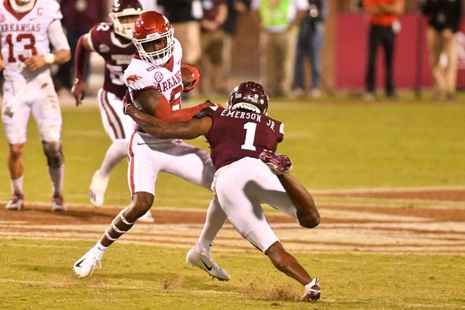 Oct 3, 2020; Starkville, Mississippi, USA; Arkansas Razorbacks wide receiver Mike Woods (8) is tackled by Mississippi State Bulldogs cornerback Martin Emerson (1) during the second quarter at Davis Wade Stadium at Scott Field.