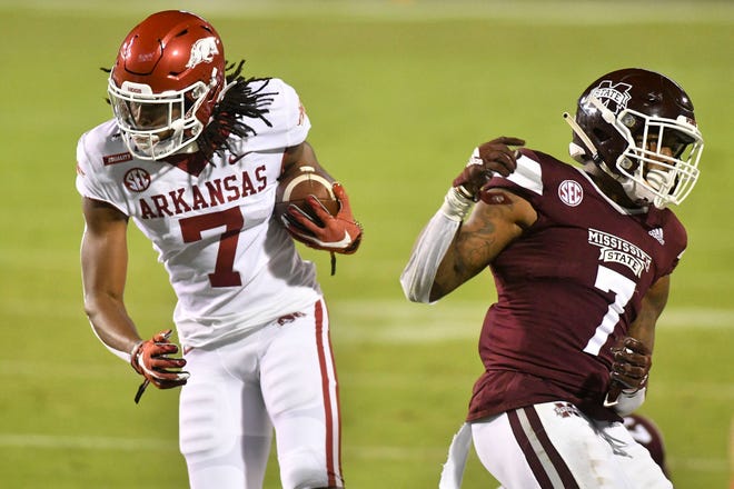 Oct 3, 2020; Starkville, Mississippi, USA; Arkansas Razorbacks wide receiver Trey Knox (7) runs the ball defended by Mississippi State Bulldogs safety Marcus Murphy (7) during the second half at Davis Wade Stadium at Scott Field.